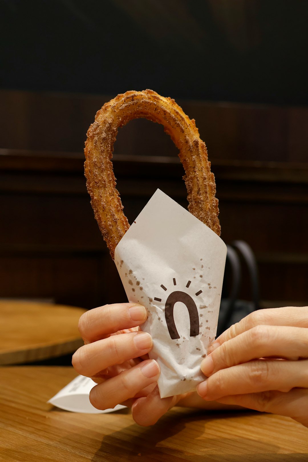 a-person-holding-a-pretzel-in-their-hand-ipf4mlwu69s